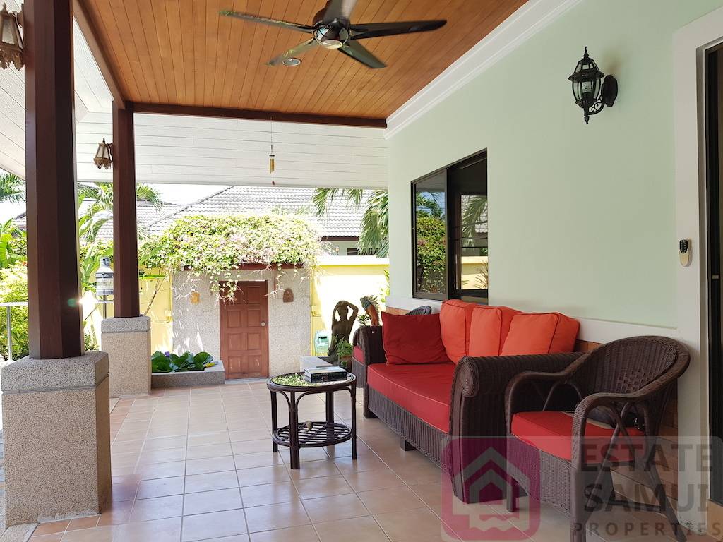 covered terrace area looking over the pool and gardens