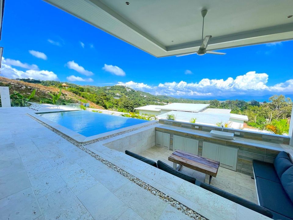 pool-side sunken sala with outdoor kitchen