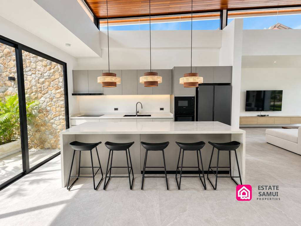 Open-plan kitchen with white island in this Bangrak pool villa
