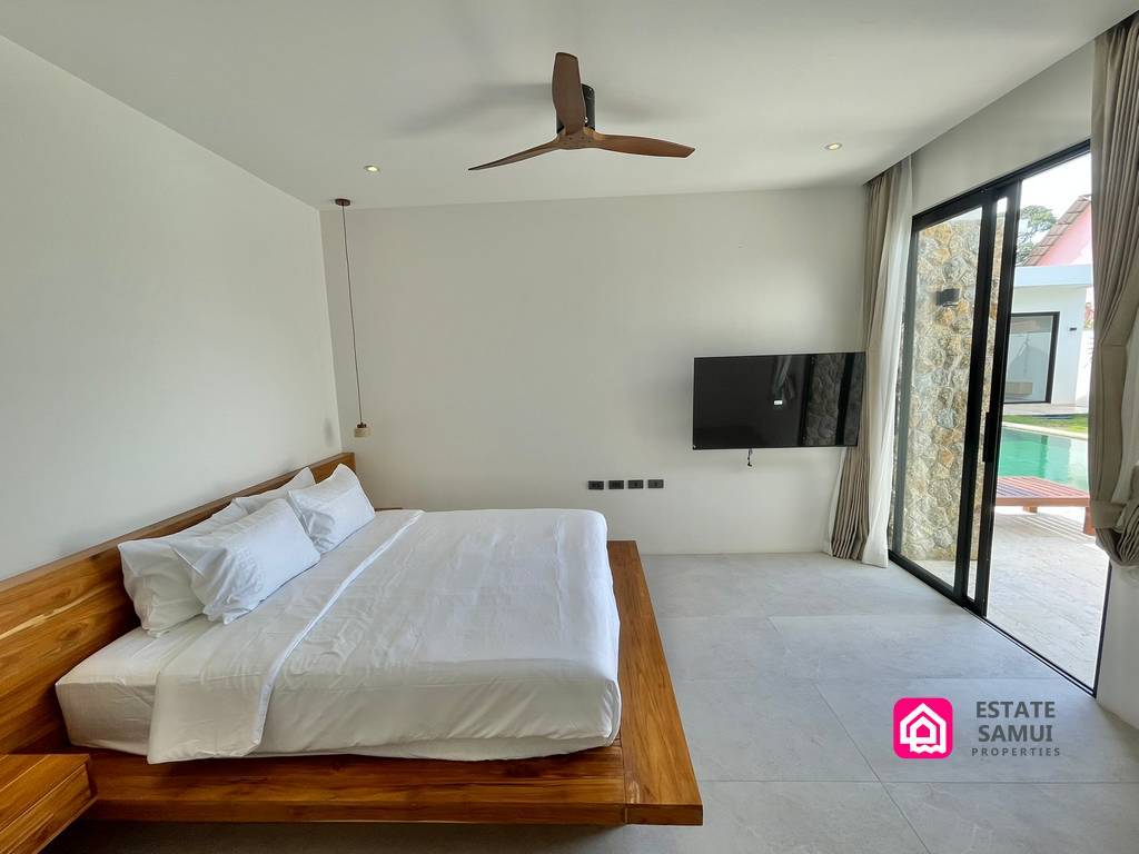 Bedroom with sliding glass doors overlooking the pool