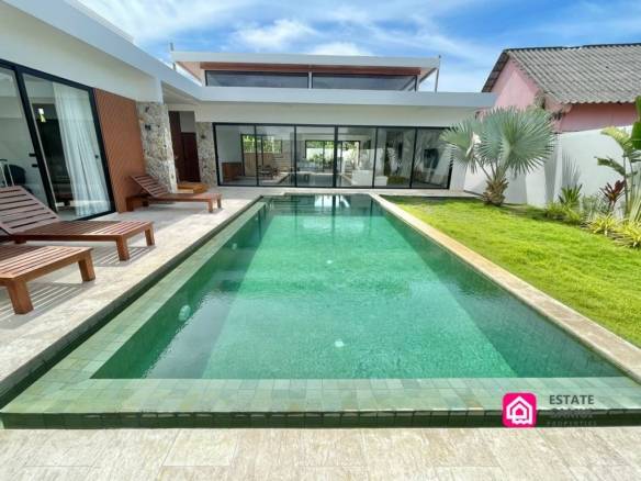 Swimming pool facing this Bangrak pool villa’s glass-fronted rooms