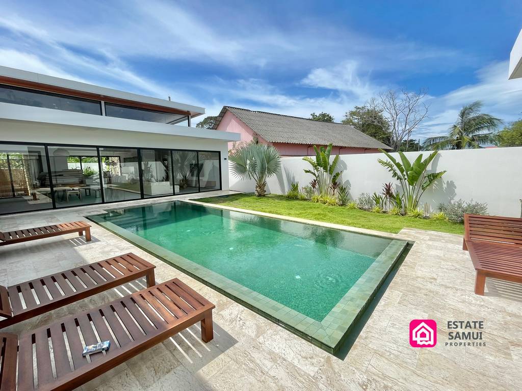 Wooden loungers beside the private swimming pool
