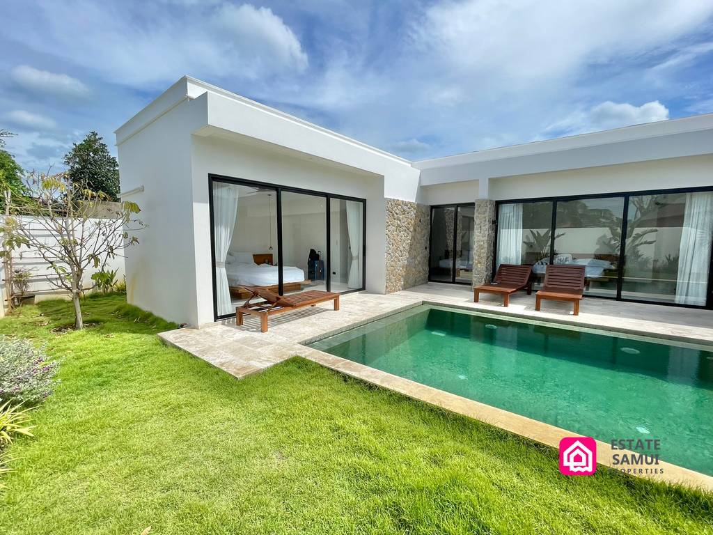 Exterior of the pool villa in Bangrak with lawn and glass doors