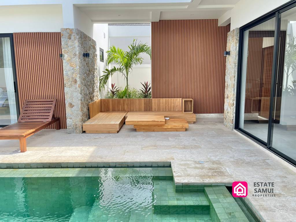 Covered wooden seating area overlooking the pool