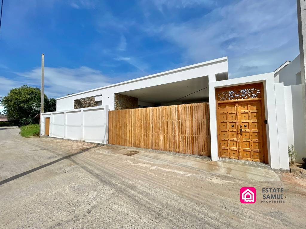 Bangrak villa frontage with covered parking and timber gate