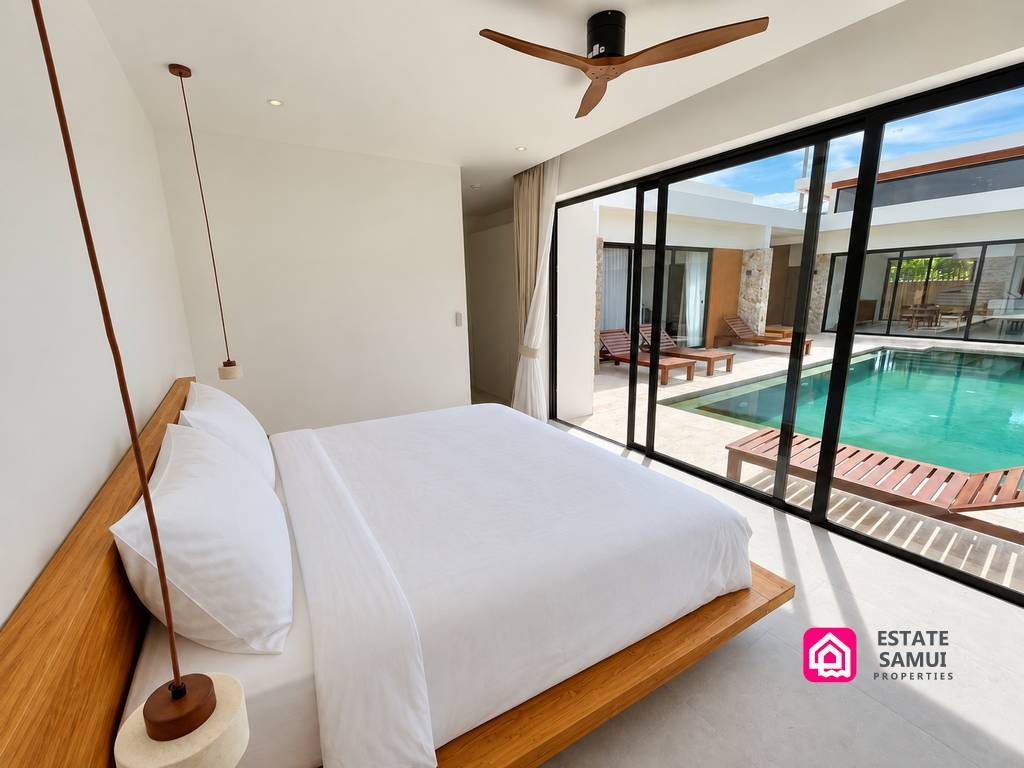 Bedroom with glass doors overlooking the swimming pool