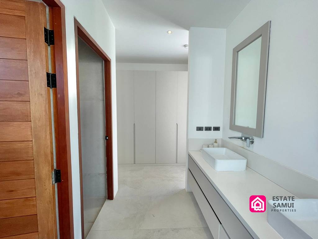 Double-basin vanity leading towards the bedroom