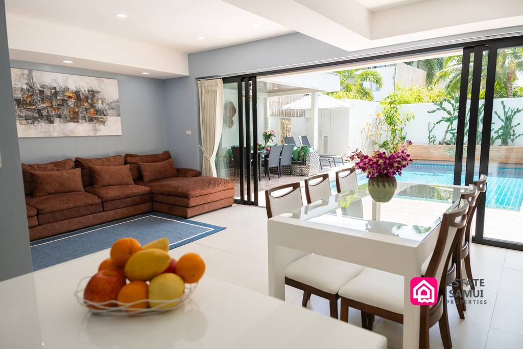 Open-plan living and dining area overlooking private swimming pool