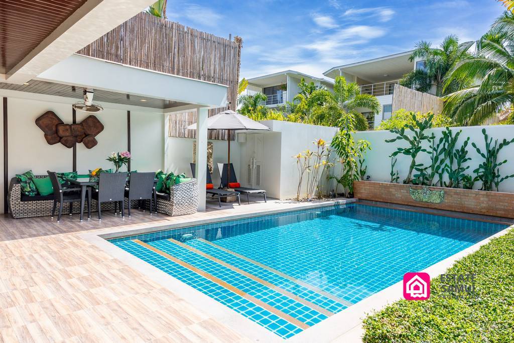 Private swimming pool with shaded outdoor dining and sun loungers