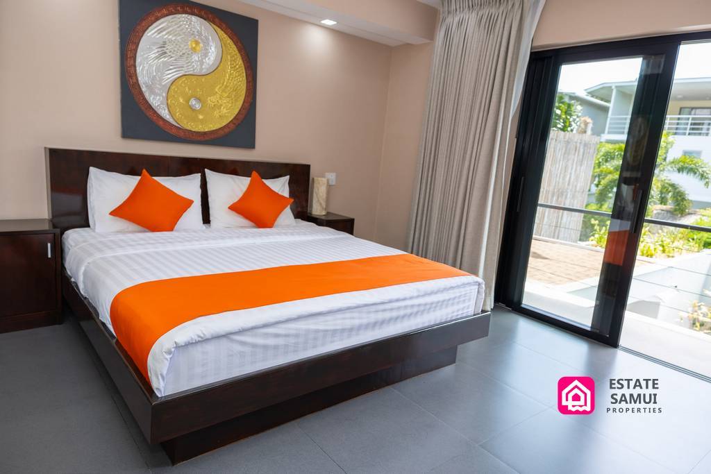 Double bedroom with balcony doors and orange accent furnishings