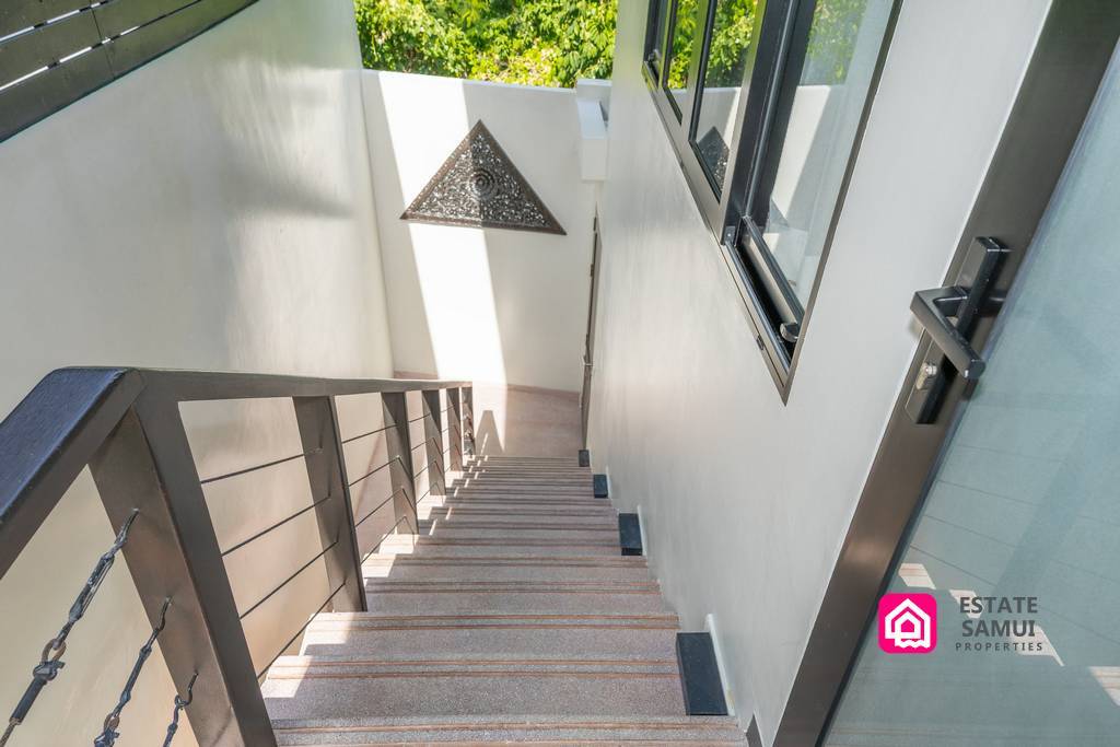 Exterior staircase connecting upper and lower villa levels