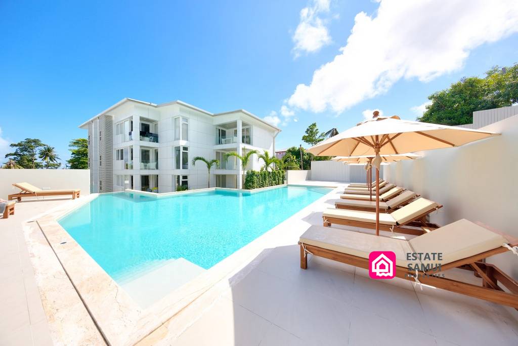 Large communal pool with sun loungers and parasols