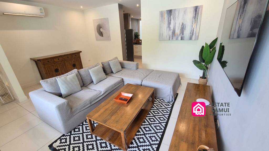 Furnished living area with sectional sofa and wooden coffee table
