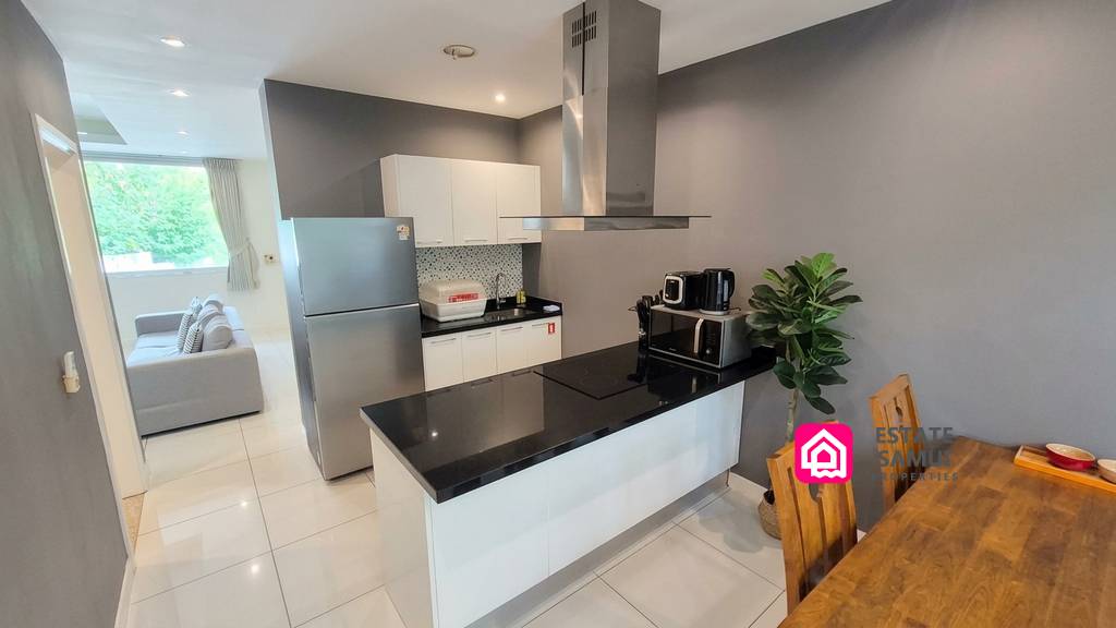 Modern open kitchen with breakfast bar and adjoining dining area