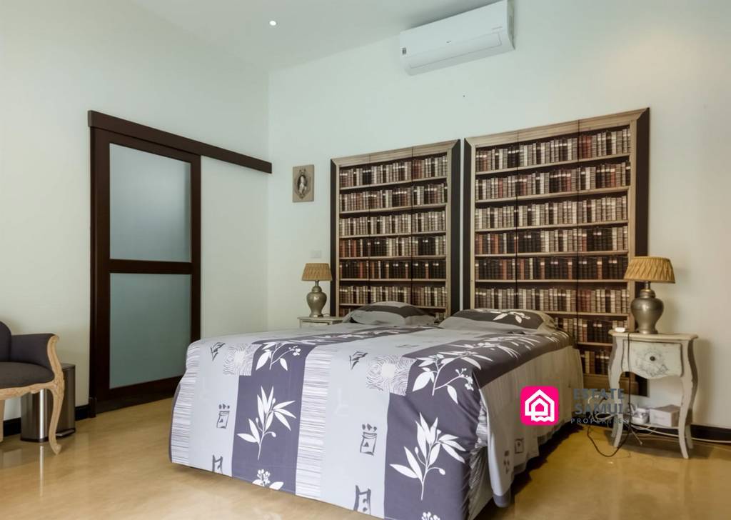 Air-conditioned double bedroom with decorative bookcase-style headboard