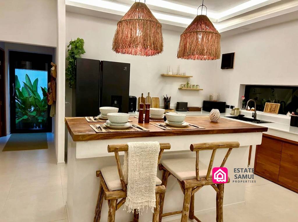 Kitchen island with dining stools and woven pendant lights