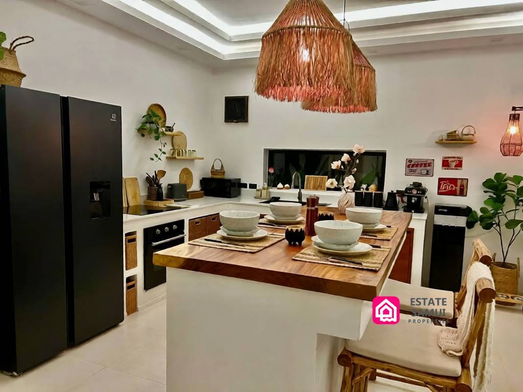 Kitchen with island seating, dark refrigerator and woven pendant light