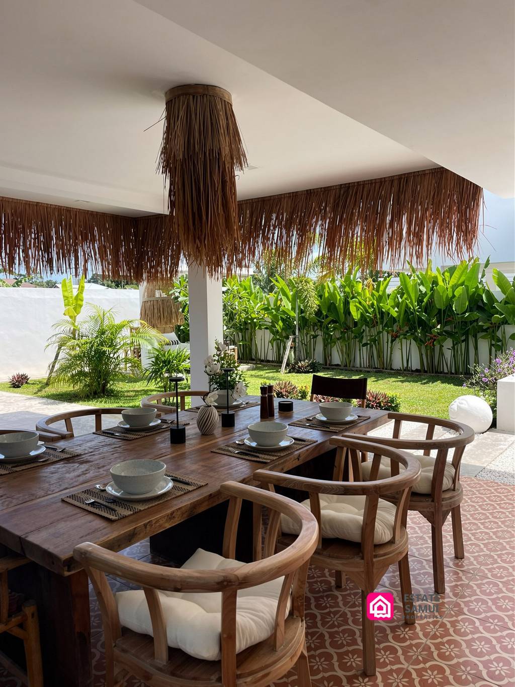 Covered outdoor dining table beside the garden