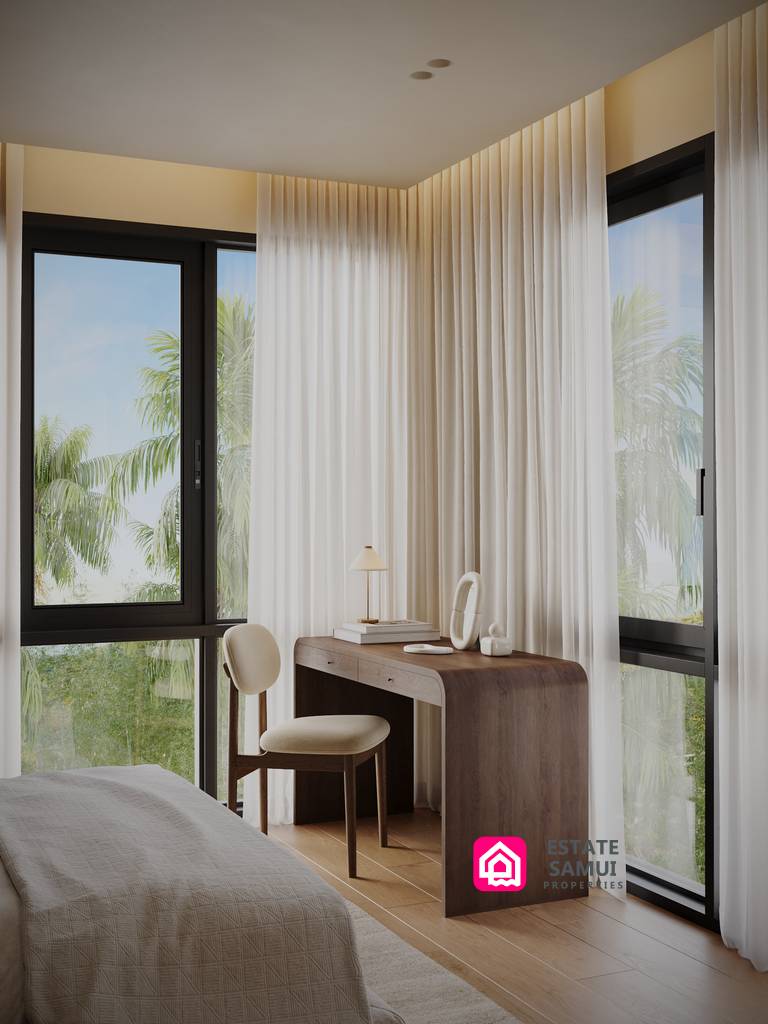 Bedroom workspace beside two tall windows