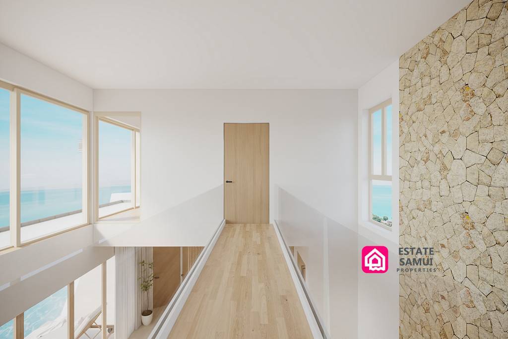 Upper-floor walkway with stone feature wall and ocean views