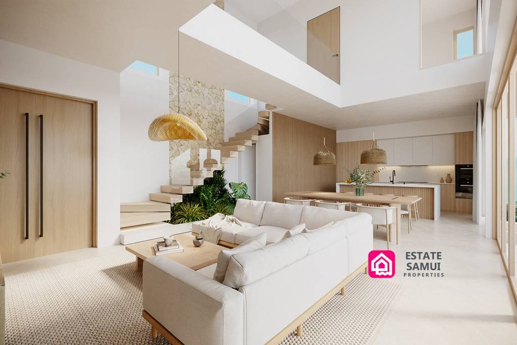 Bright open-plan living room with timber kitchen and staircase