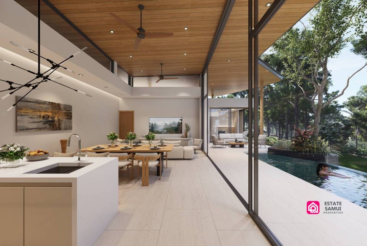 Kitchen island and dining space overlooking the pool through full-height glazing.