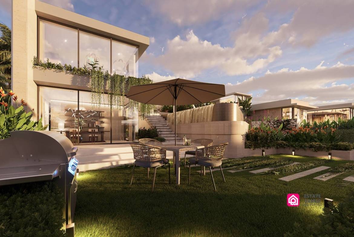 Garden dining terrace with barbecue, umbrella and outdoor seating.