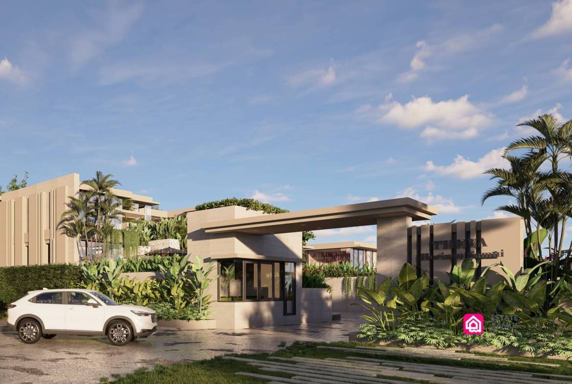 Landscaped entrance with gatehouse, broad canopy and vehicle access.