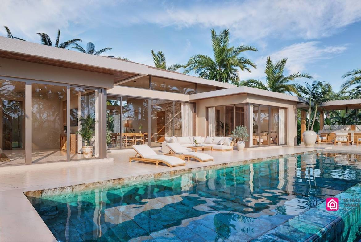 Swimming pool beside villa terrace with loungers and glazed doors
