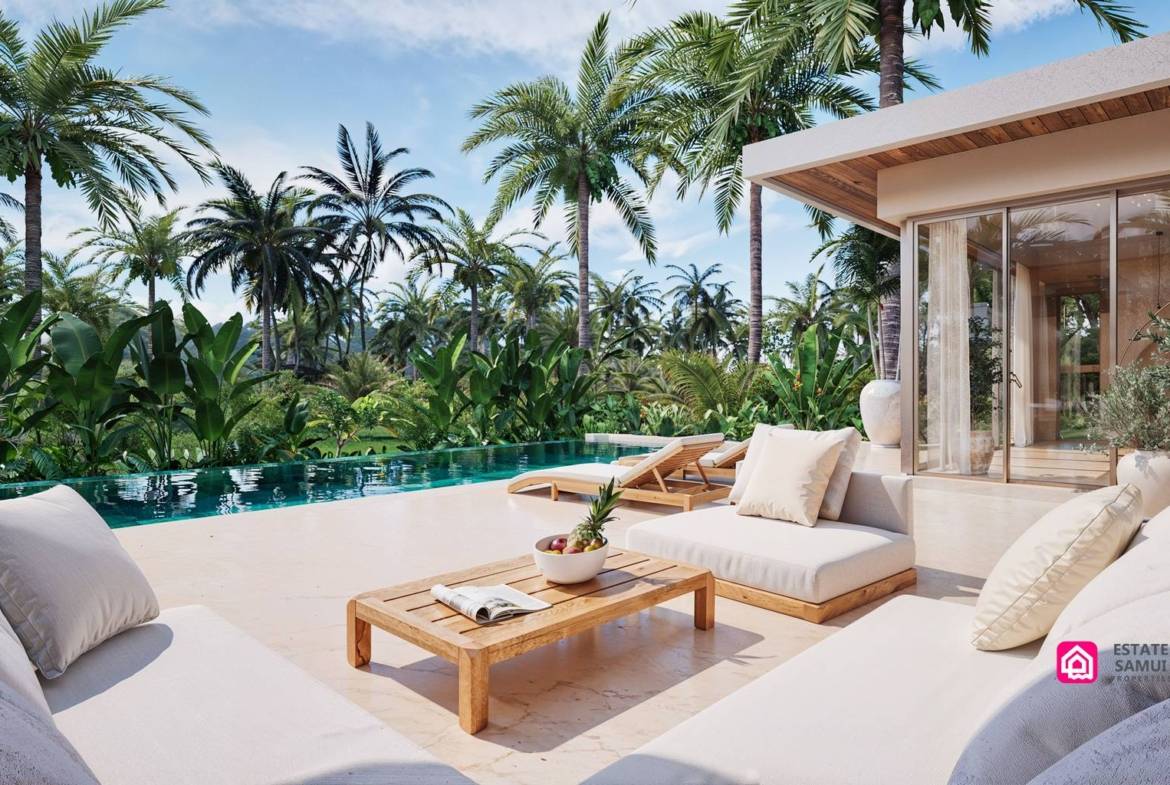 Poolside loungers and outdoor sofa beside glazed living room doors