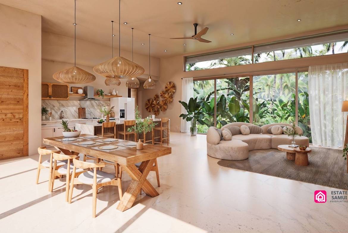 Open-plan interior with dining table, kitchen and curved sofa
