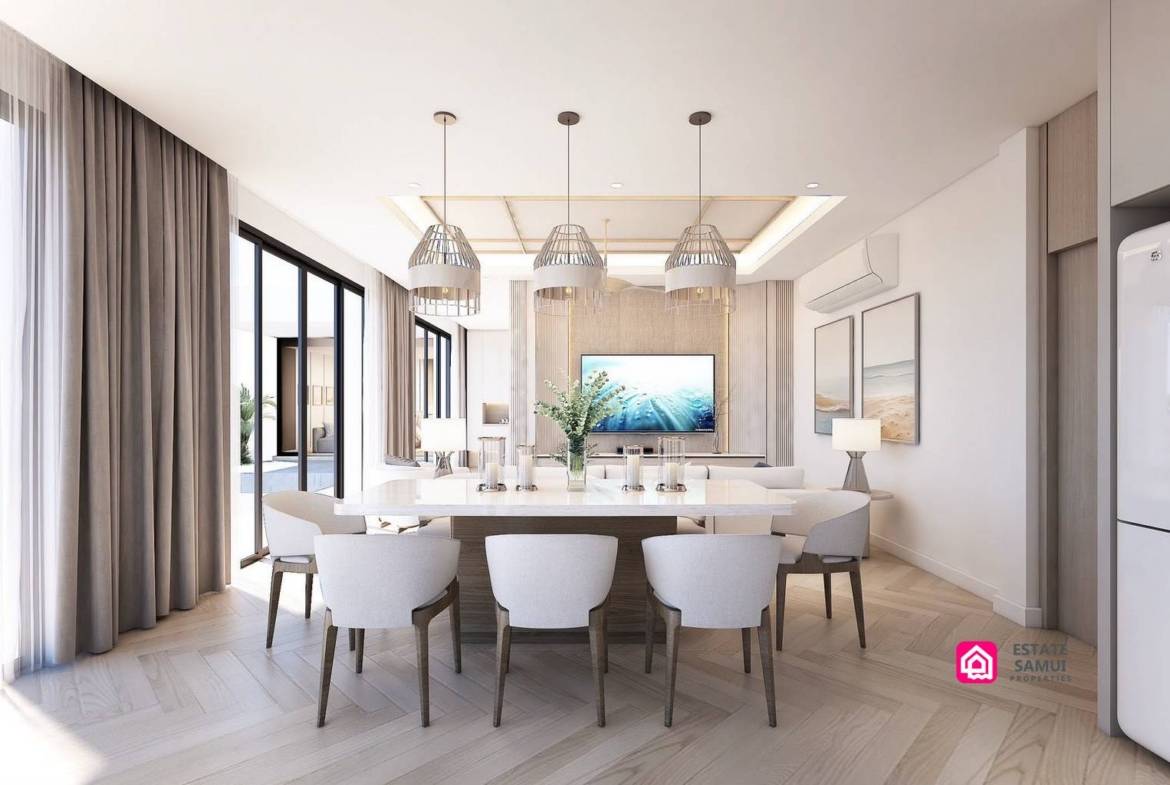 Dining table beneath pendant lights beside full-height glazed doors