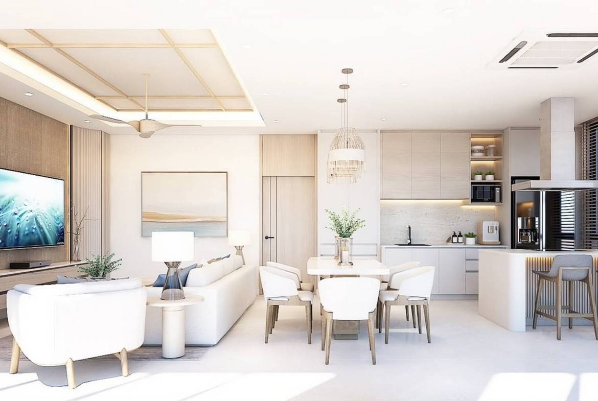 Living, dining and kitchen areas opening towards the poolside terrace