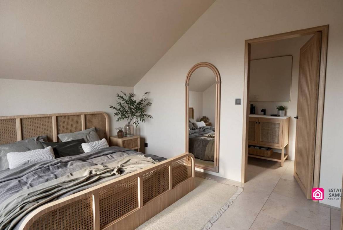 Bedroom with wooden bed frame, arched mirror and adjoining bathroom doorway.
