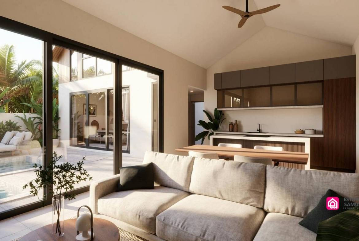 Open-plan living area with sofa, dining table and kitchen beside the pool.