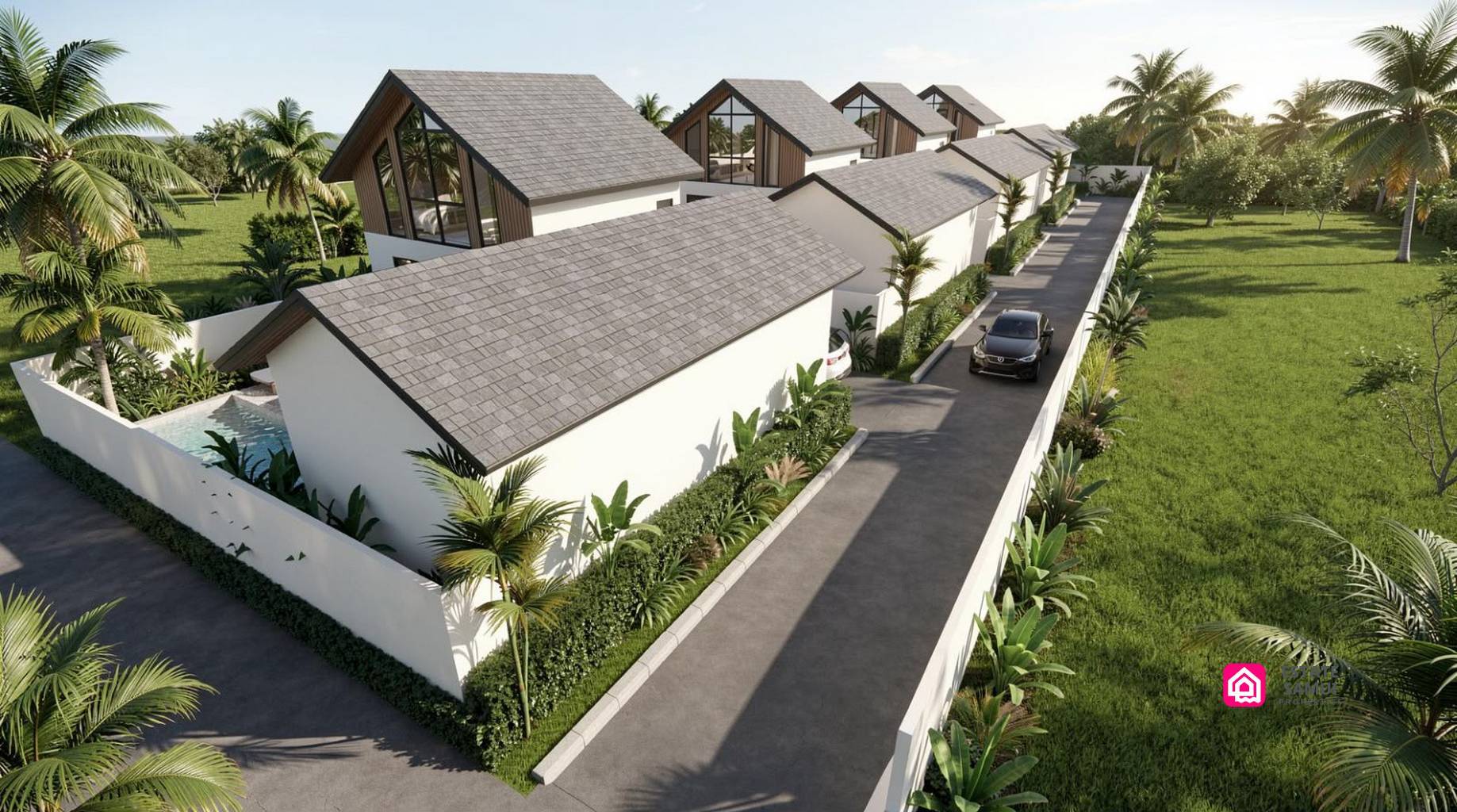 Aerial view of pitched-roof villas and parking along an internal access road.