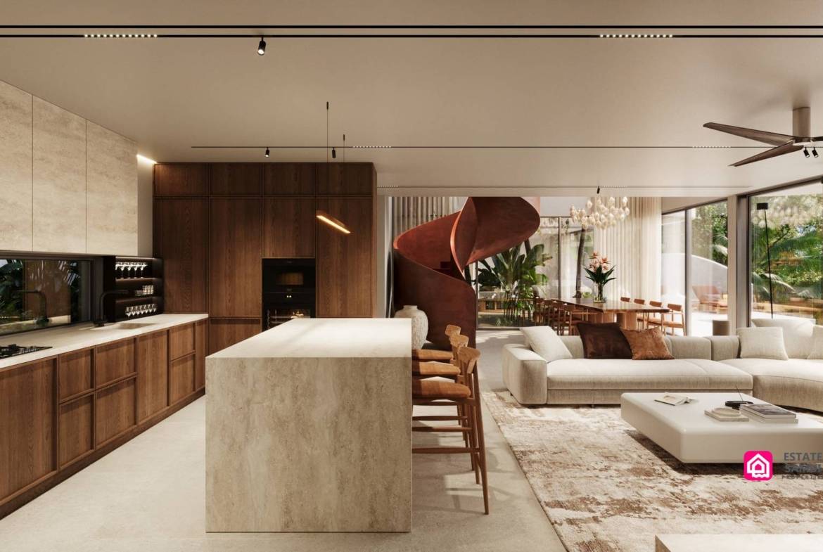 Open-plan kitchen with pale island, timber cabinetry and adjoining lounge.