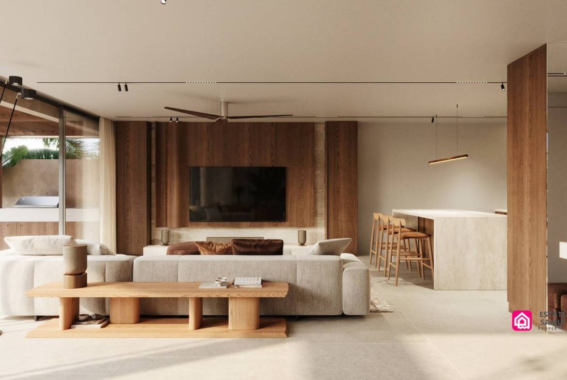 Living area with cream seating, kitchen breakfast bar and covered terrace access.