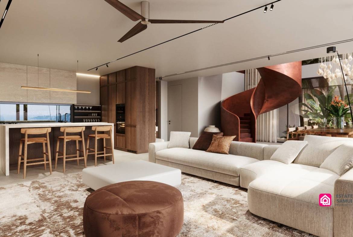 Cream sectional sofa beside kitchen island and sculptural red staircase.