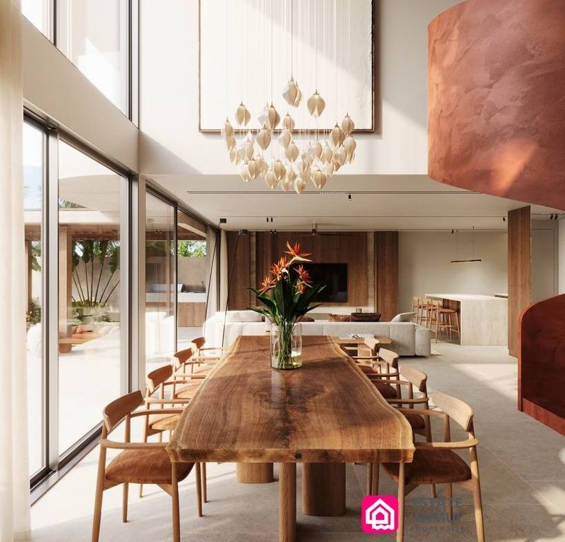 Double-height dining area with wooden table and cascading pendant chandelier.
