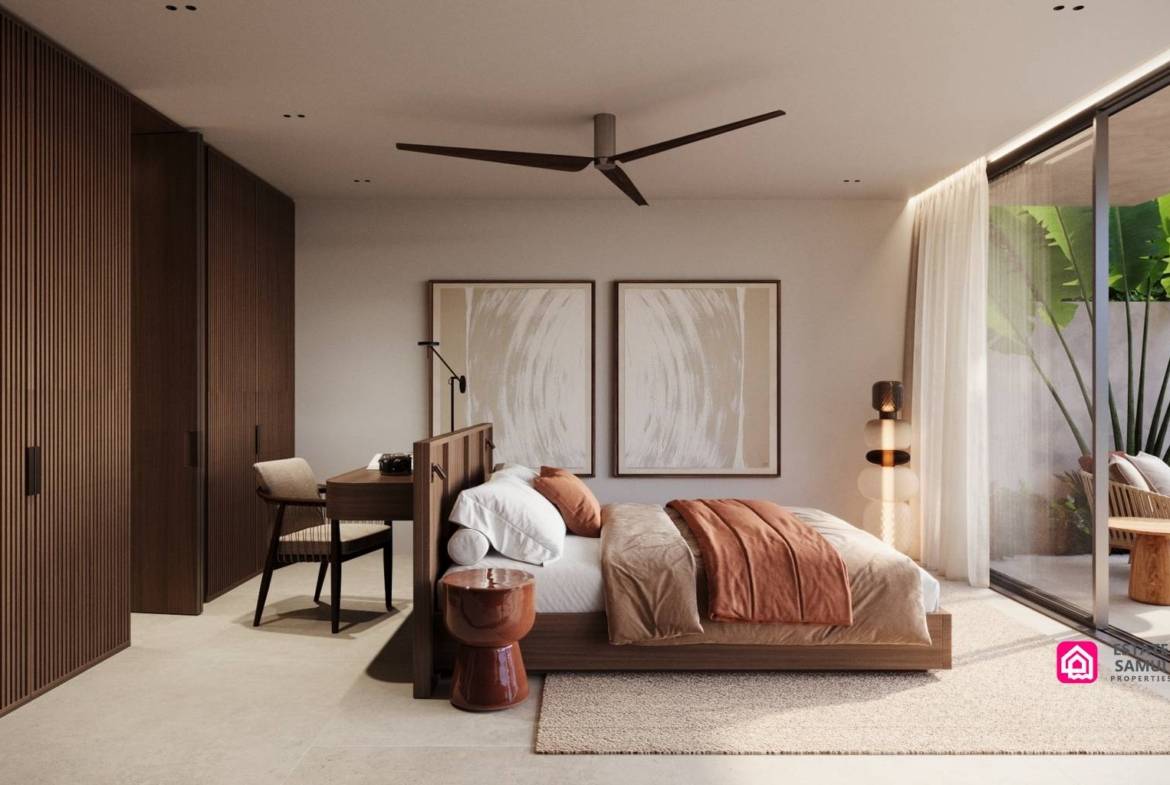 Bedroom with fitted wardrobes, desk and sliding doors to planted courtyard.